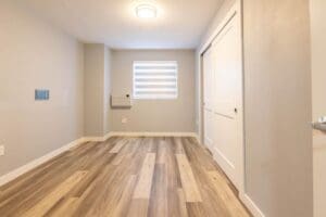 A room with wood floors and white walls.