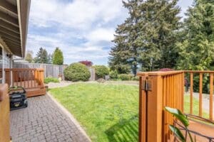 A wooden fence with grass growing on it.